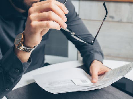 man checking financial app on smartphone