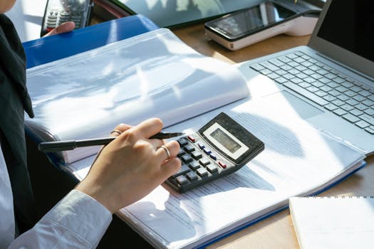 person creating a budget on a laptop