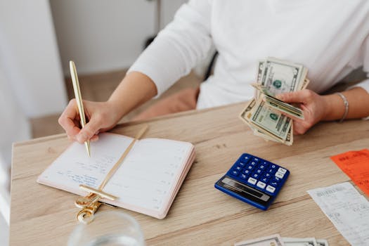 a person using a calculator to manage finances