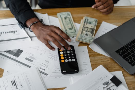 person using calculator for financial figures