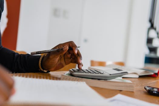 A person budgeting with pen and paper