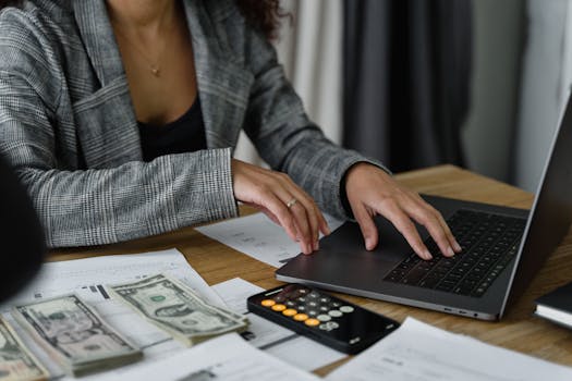 A person setting up their budget on a laptop